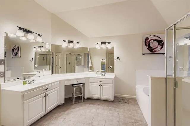 a spacious bathroom with a double vanity sink mirror and double