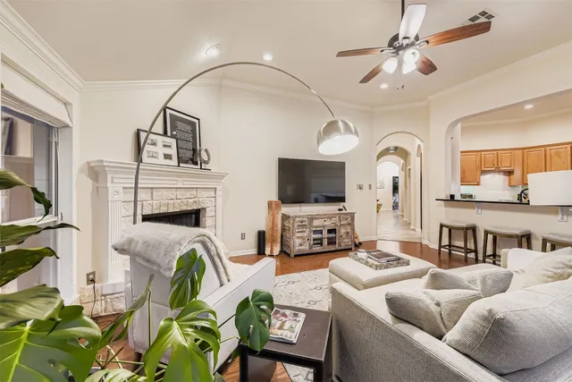 a living room with furniture a fireplace and a flat screen tv