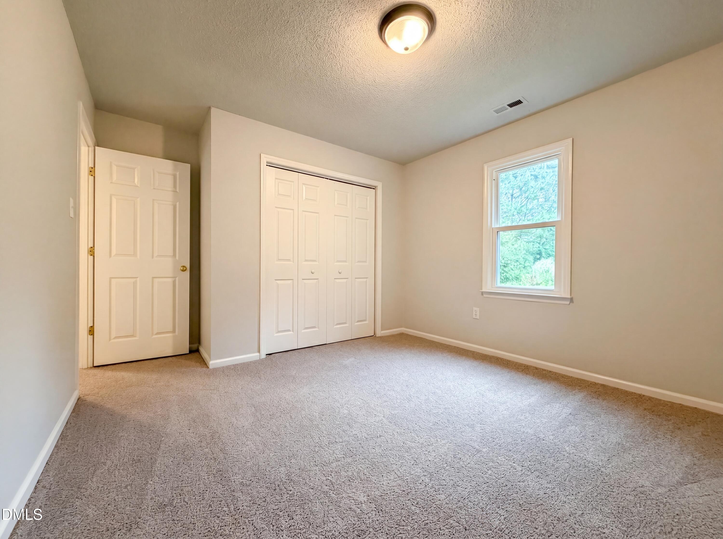 4894 Elevation Road, Unit C Benson, NC 27504 - Photo 12 of 24 an empty room with windows