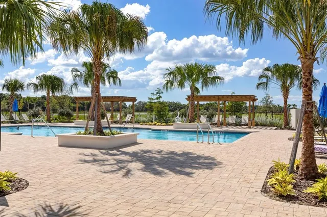 a view of a swimming pool with a table and chairs