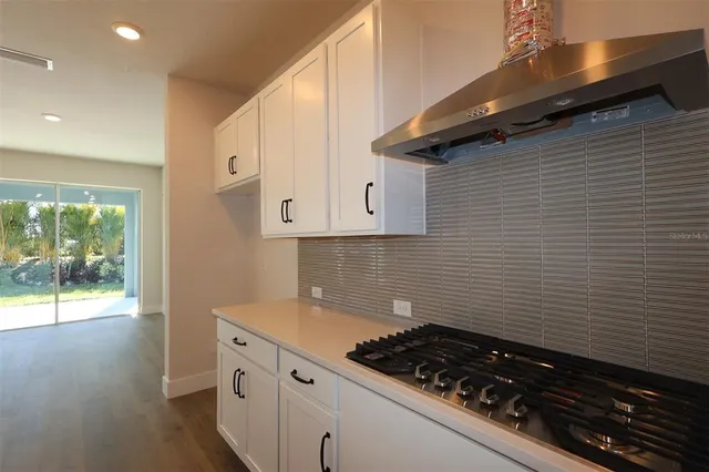 a kitchen with a stove and a wooden cabinets