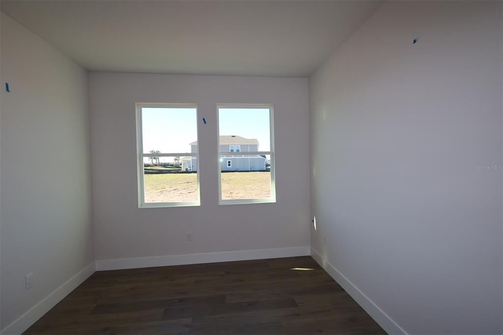 5263 Everlong Drive Apollo Beach, FL 33572 - Photo 10 of 18 an empty room with wooden floor and windows