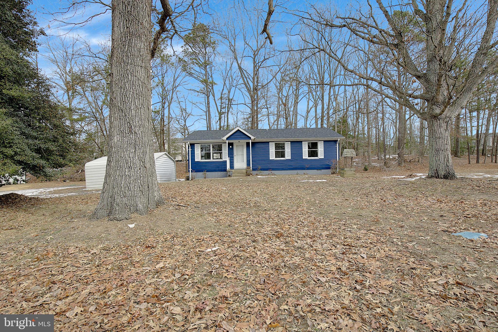 12070 Rousby Hall Road Lusby, MD 20657 - Photo 1 of 36 front view of house with a yard