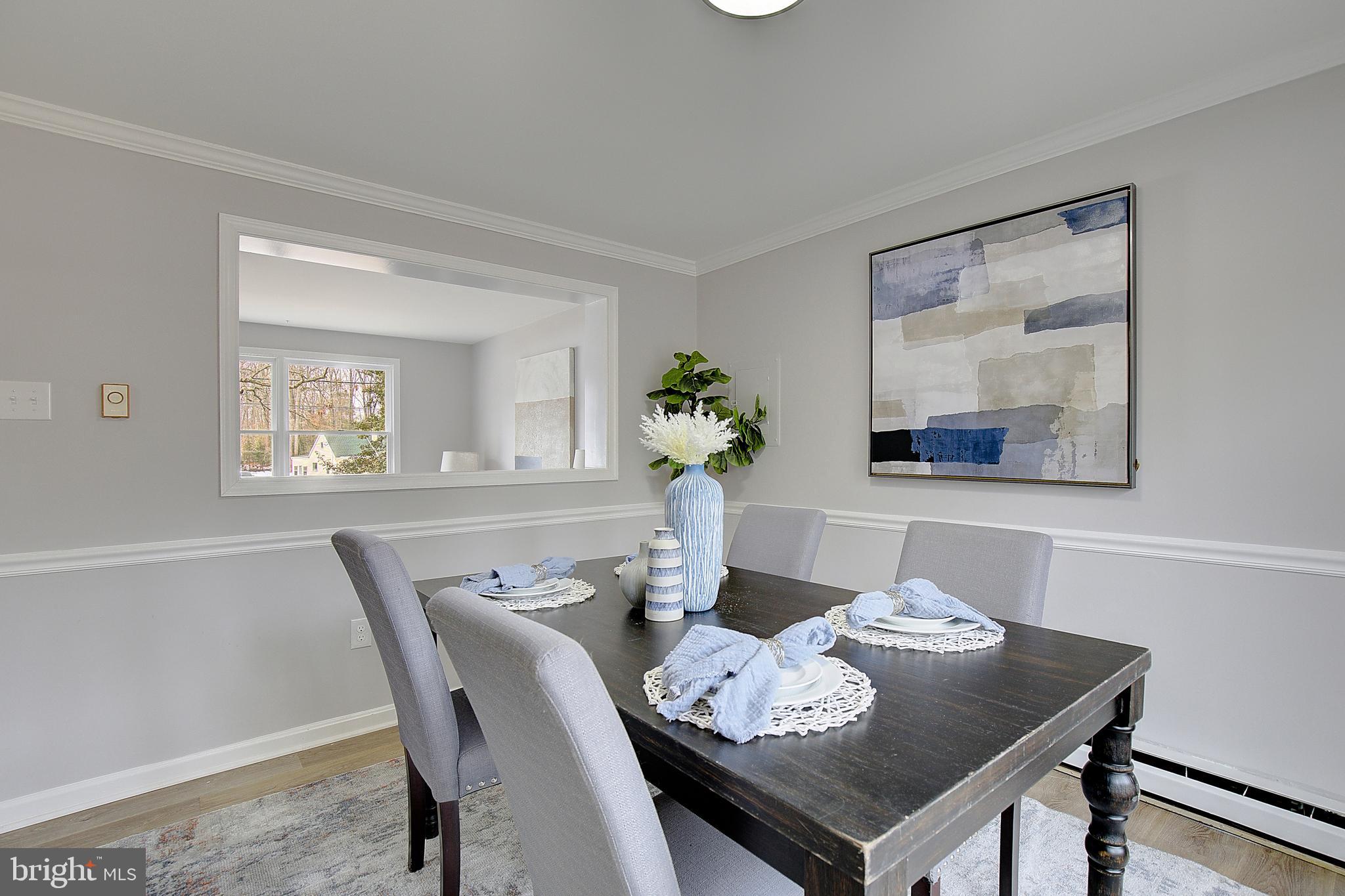12070 Rousby Hall Road Lusby, MD 20657 - Photo 14 of 36 a view of a dining room with furniture window and wooden floor
