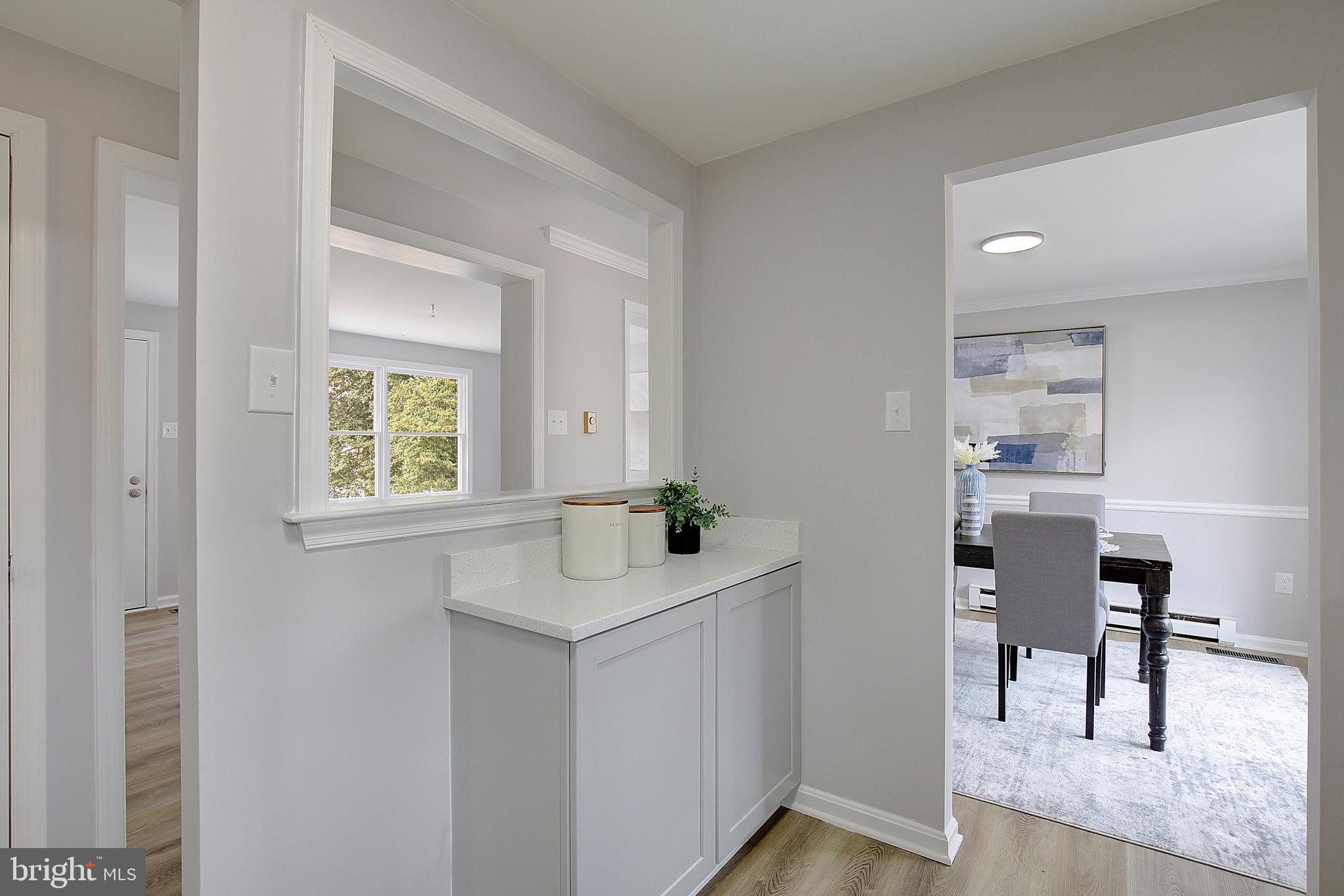 12070 Rousby Hall Road Lusby, MD 20657 - Photo 18 of 36 a bathroom with a sink a window and a mirror