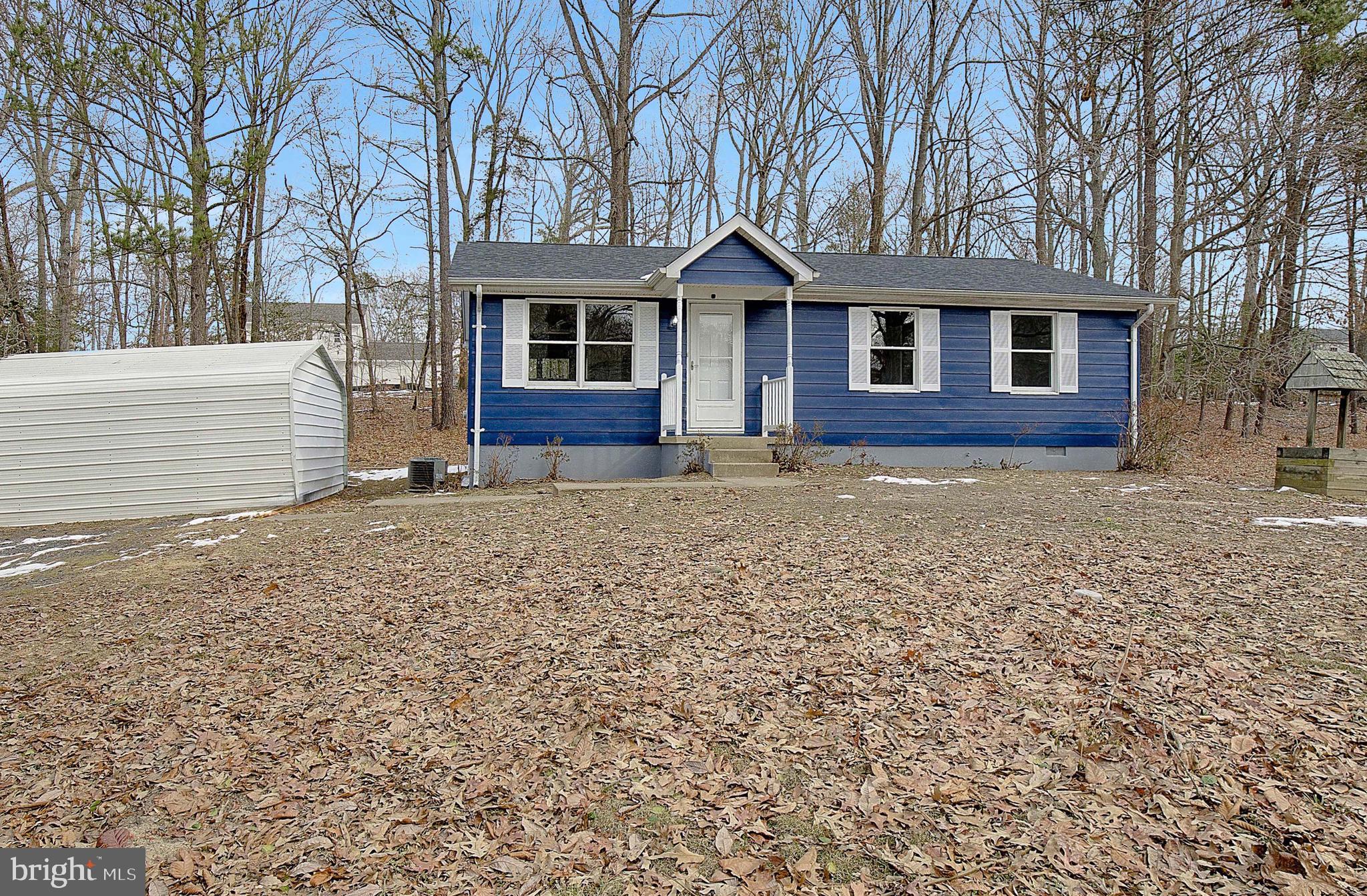 12070 Rousby Hall Road Lusby, MD 20657 - Photo 2 of 36 a front view of a house with garden