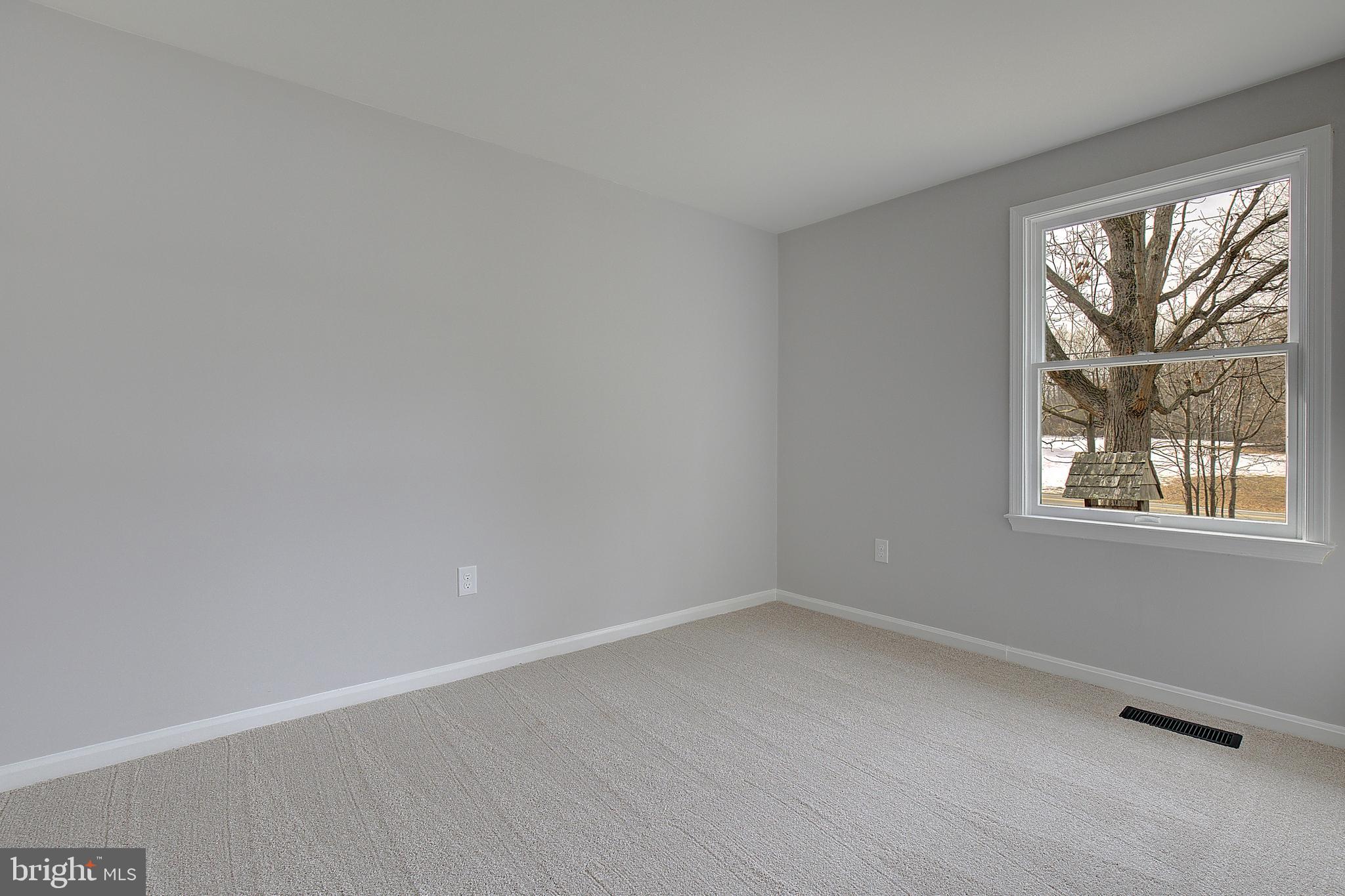 12070 Rousby Hall Road Lusby, MD 20657 - Photo 23 of 36 wooden floor in an empty room with a window