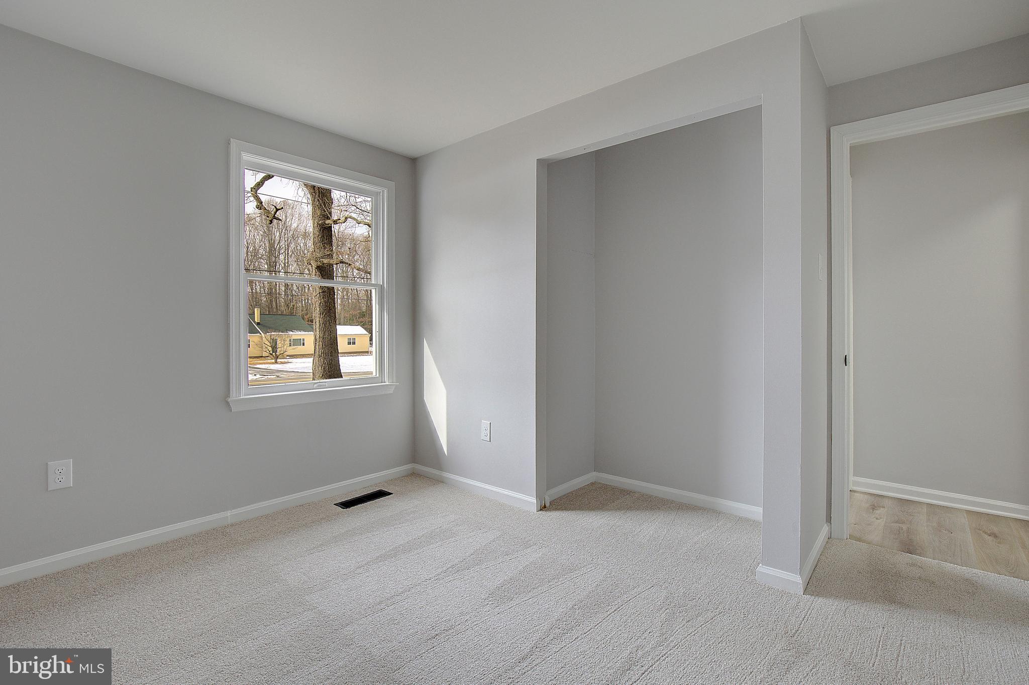 12070 Rousby Hall Road Lusby, MD 20657 - Photo 24 of 36 an empty room with windows and closet