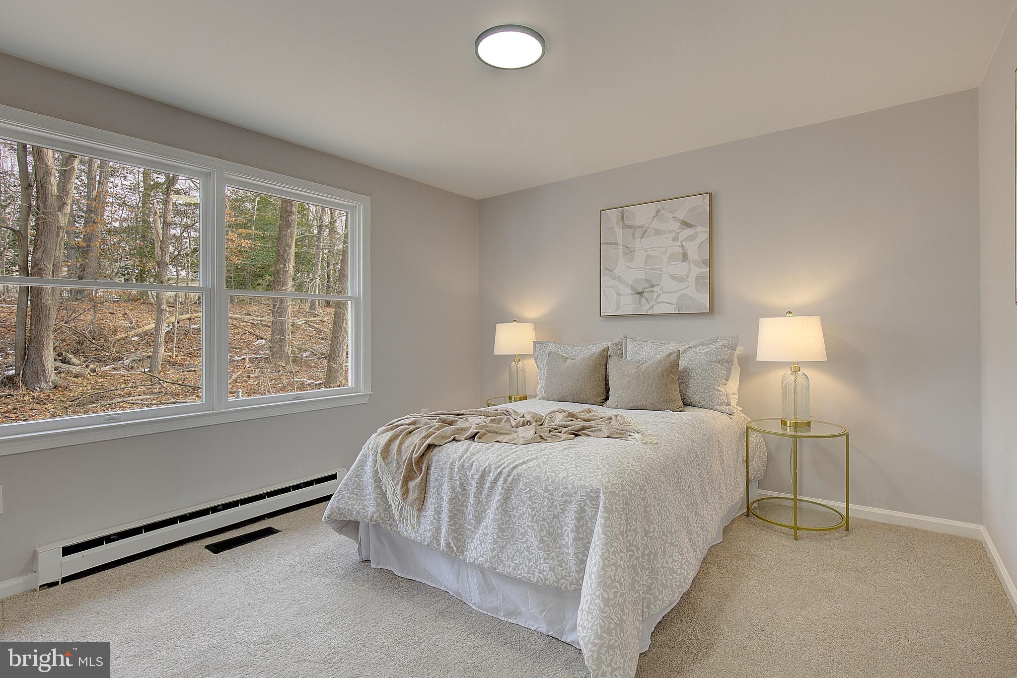 12070 Rousby Hall Road Lusby, MD 20657 - Photo 25 of 36 a bedroom with a bed and a large window