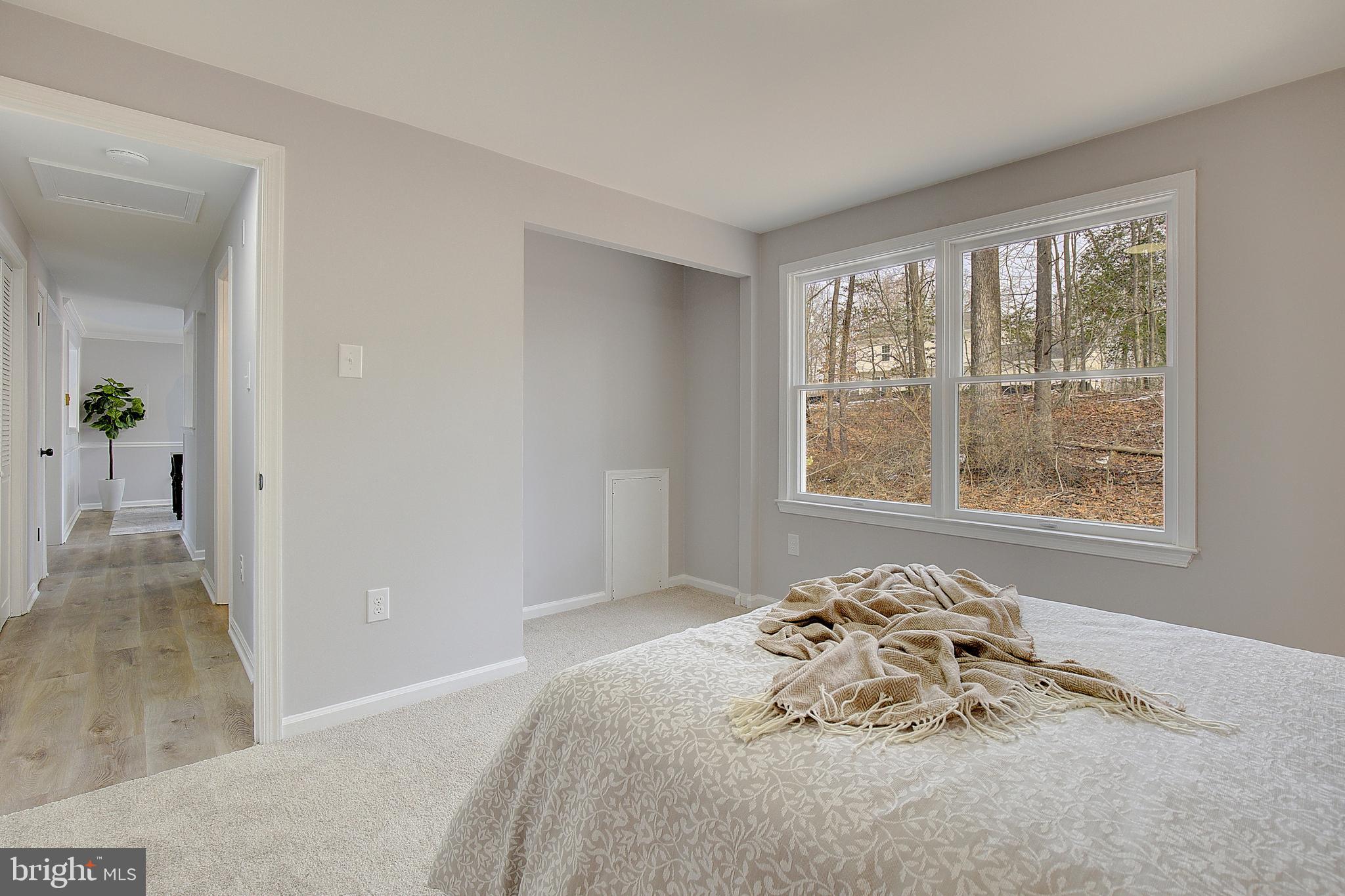 12070 Rousby Hall Road Lusby, MD 20657 - Photo 26 of 36 a bedroom with a bed and a window