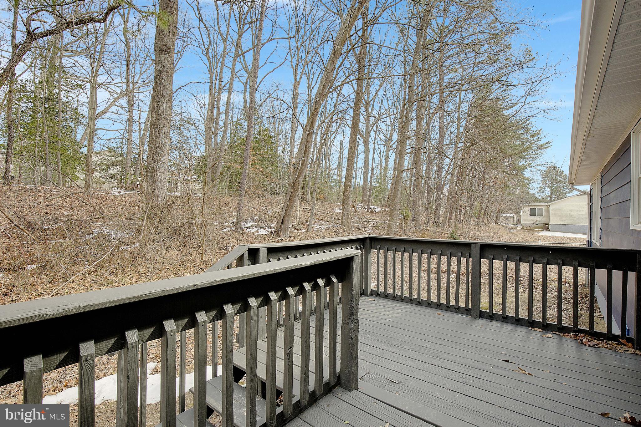 12070 Rousby Hall Road Lusby, MD 20657 - Photo 28 of 36 a view of deck with wooden fence and trees