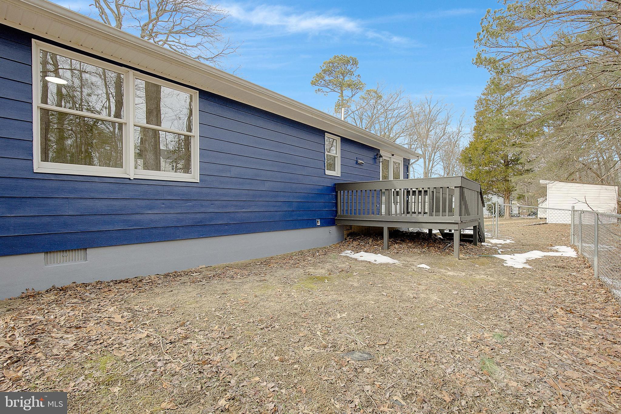 12070 Rousby Hall Road Lusby, MD 20657 - Photo 32 of 36 a view of a house with a yard