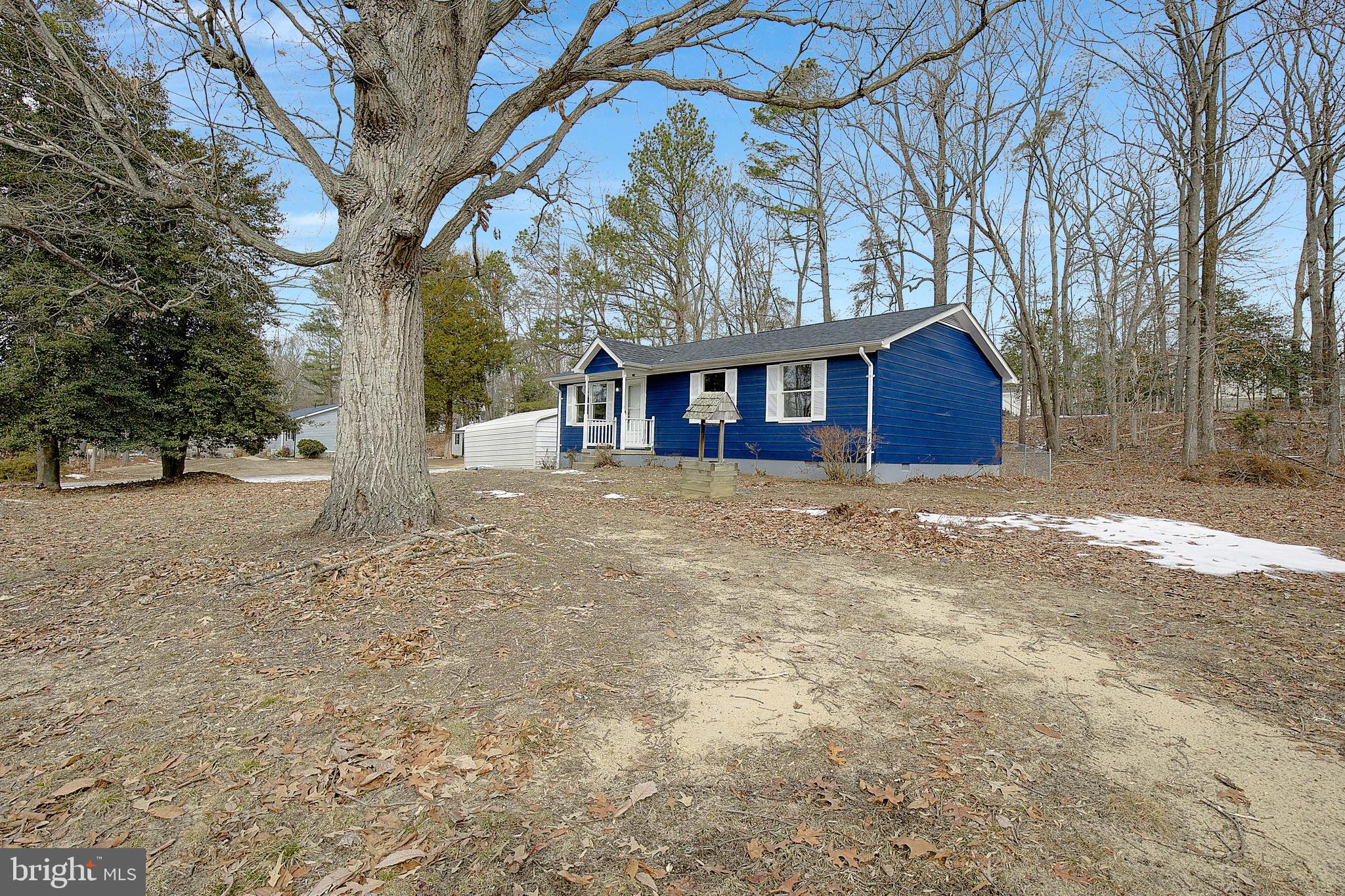12070 Rousby Hall Road Lusby, MD 20657 - Photo 5 of 36 a view of large house with a large tree