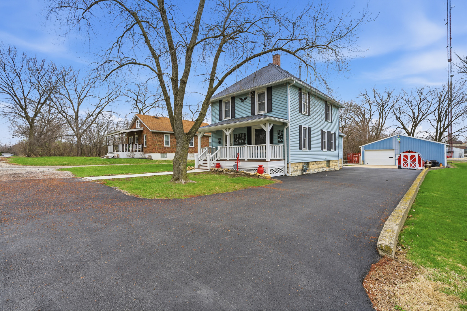 a front view of a house with a yard and trees
