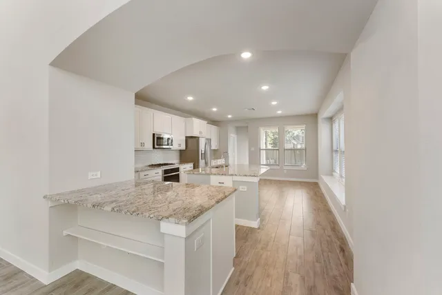 a kitchen with a stove a sink and a refrigerator
