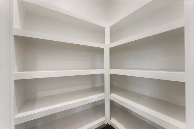 a view of walk in closet with empty racks