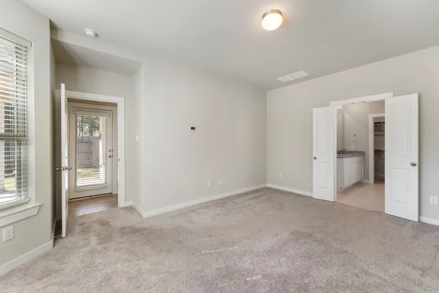 an empty room with a bathroom and a sink