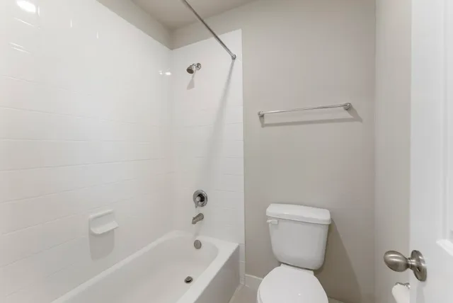 a bathroom with a toilet and a bathtub