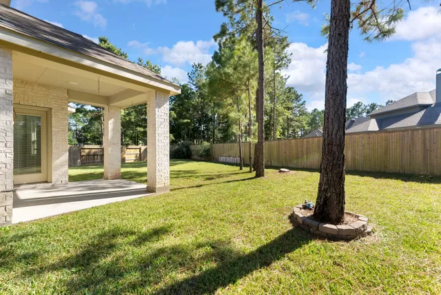 a swimming pool with yard next to a yard