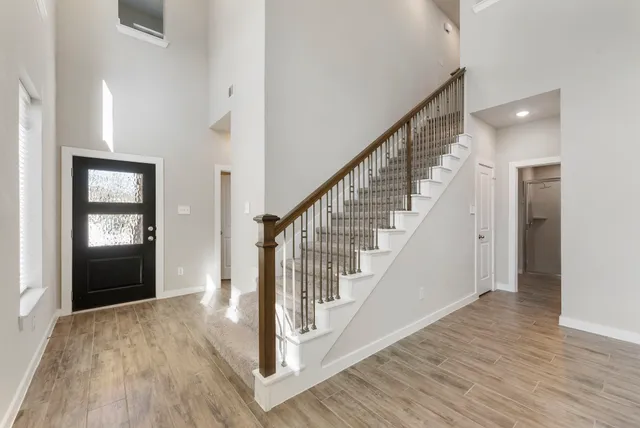 a view of entryway with wooden floor and stairs