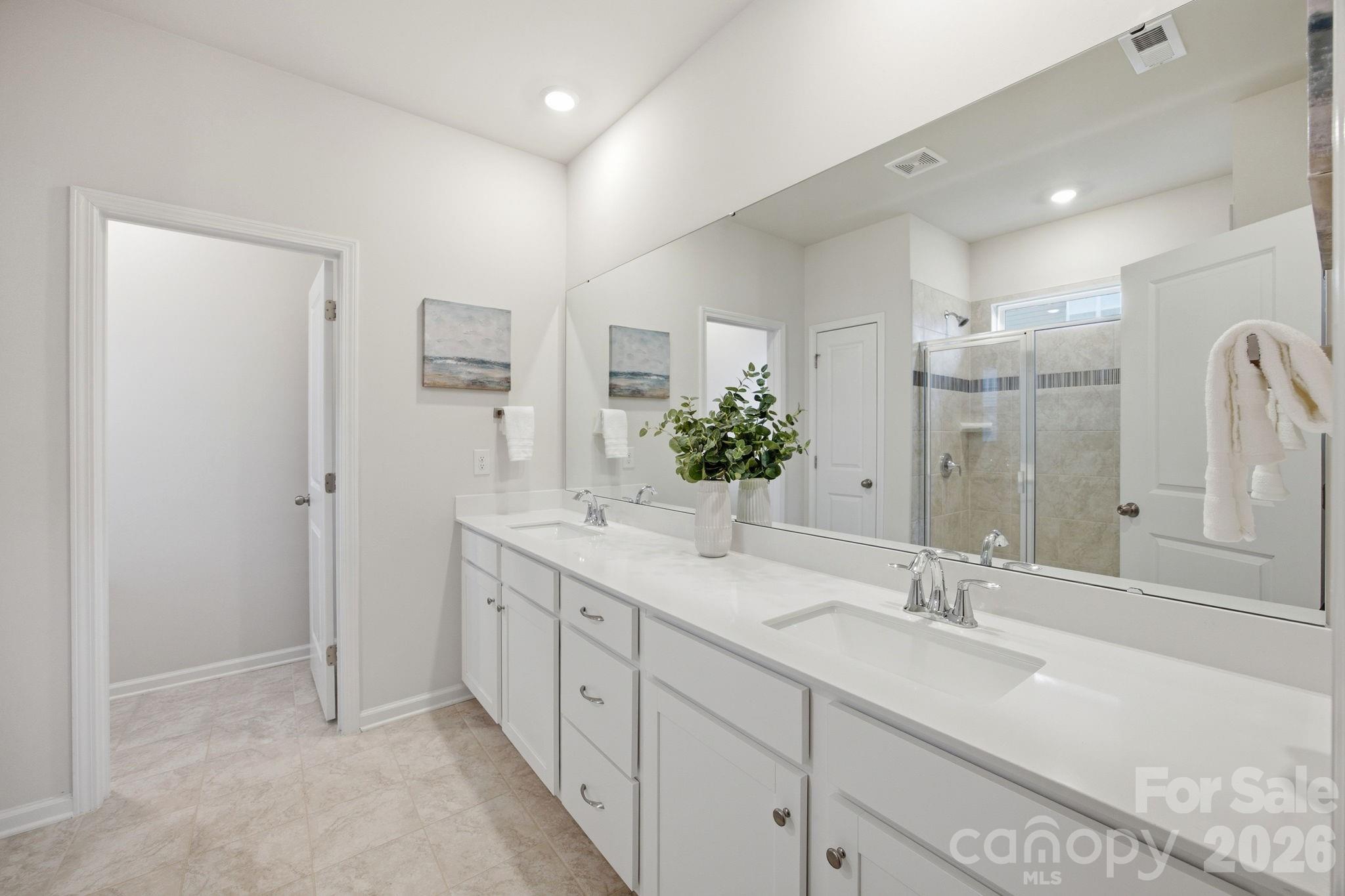 234 Hamptons Cove Road Troutman, NC 28166 - Photo 16 of 32 a bathroom with a double vanity sink mirror and