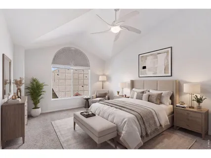 a bedroom with a large bed and a chandelier