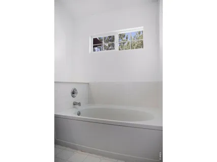 a bathroom with a bathtub and shower