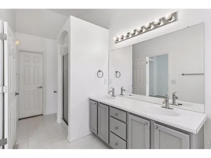 a bathroom with a sink double vanity and a mirror