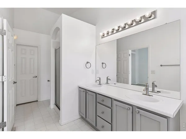 a bathroom with a sink double vanity and a mirror
