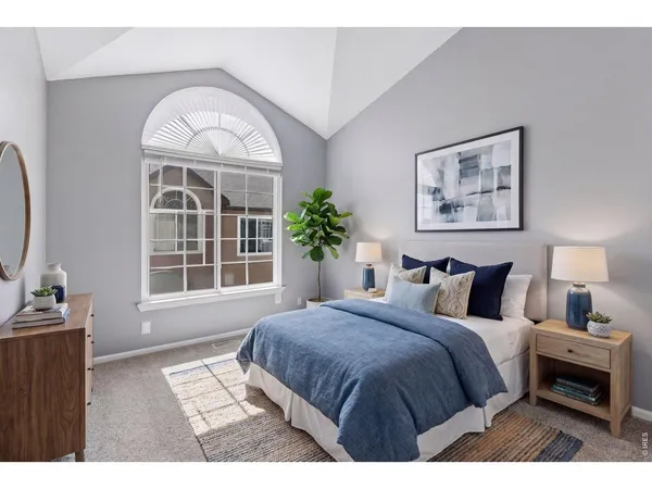 a bedroom with a bed and a large window