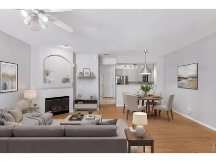 a living room with furniture a fireplace and a chandelier