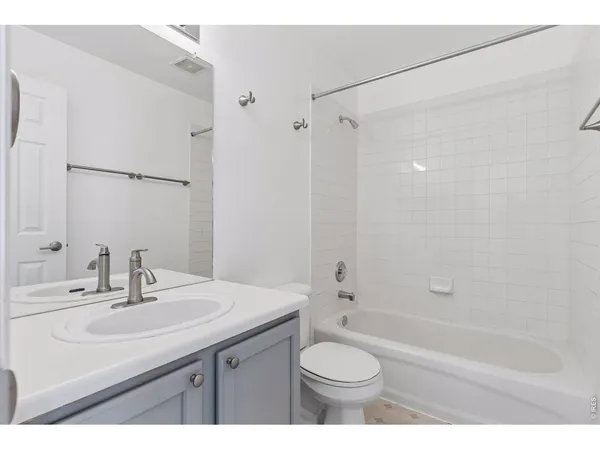 a bathroom with a sink toilet a mirror and shower