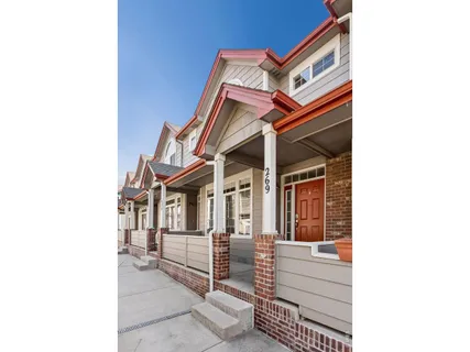 a view of a chair and tables in the patio with a backyard