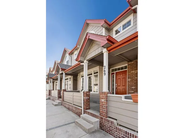 a view of a chair and tables in the patio with a backyard