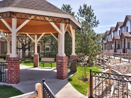 a front view of a house with a yard outdoor seating and mountain view