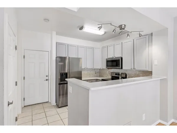 a kitchen with kitchen island a sink stainless steel appliances and cabinets