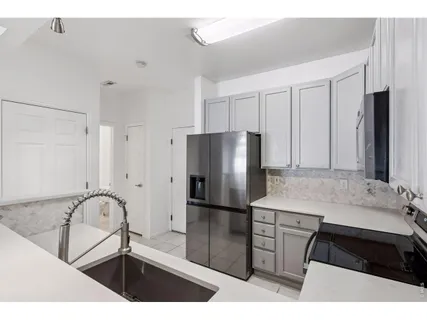 a kitchen with a refrigerator and a sink