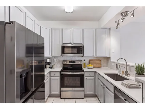 a kitchen with a sink stove and refrigerator
