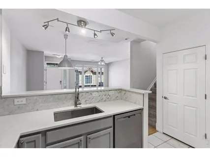 a kitchen with a sink and a mirror