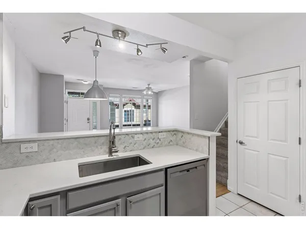 a kitchen with a sink and a mirror