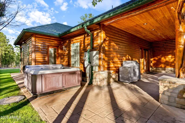 a view of a house with backyard and wooden fence