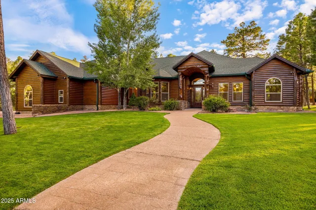 a living room with furniture kitchen view and a fireplace