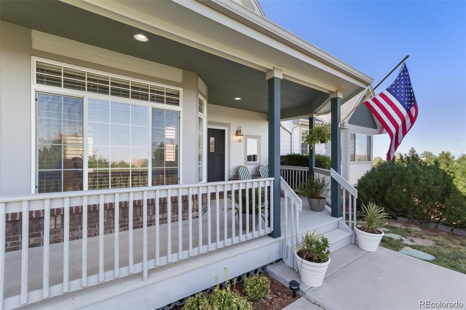 935 Green Gables Circle Bennett, CO 80102 - Photo 12 of 34 a view of a chair and table and chair and potted plants