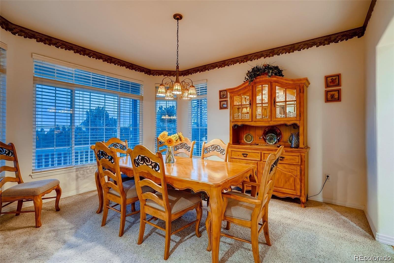 935 Green Gables Circle Bennett, CO 80102 - Photo 14 of 34 a view of a dining room with furniture and chandelier