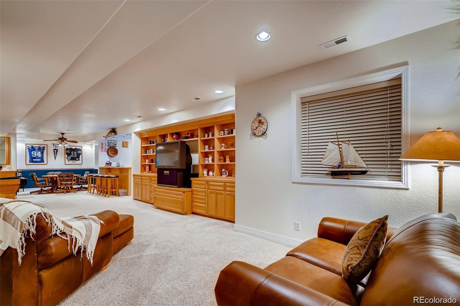 935 Green Gables Circle Bennett, CO 80102 - Photo 28 of 34 a living room with furniture a couch and a window