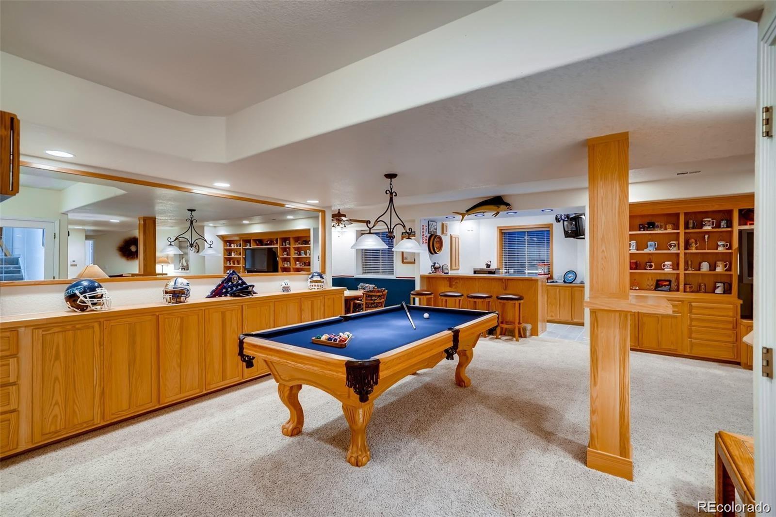 935 Green Gables Circle Bennett, CO 80102 - Photo 29 of 34 a living room with furniture pool table and chairs