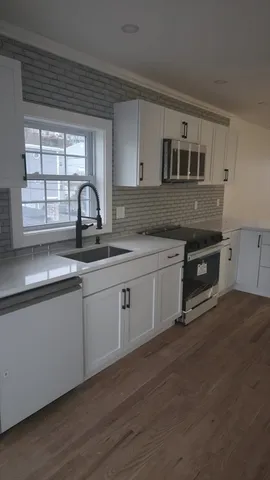 a kitchen with sink cabinets and window