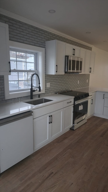a kitchen with sink cabinets and window