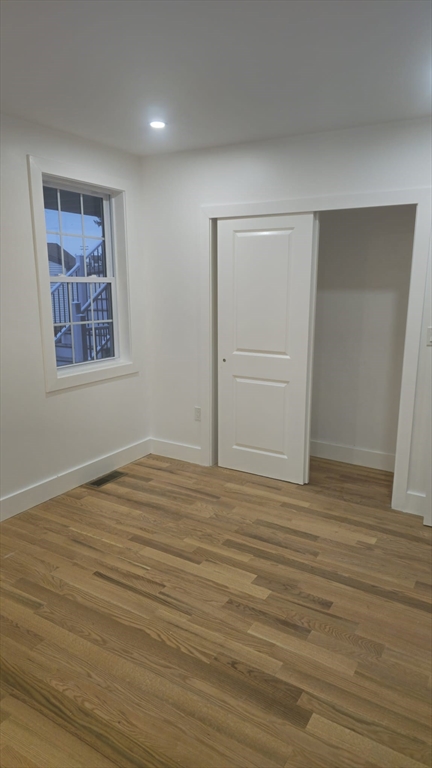 146 Dolphin Avenue, Unit 2 Revere, MA 02151 - Photo 2 of 4 a view of an empty room with wooden floor and closet