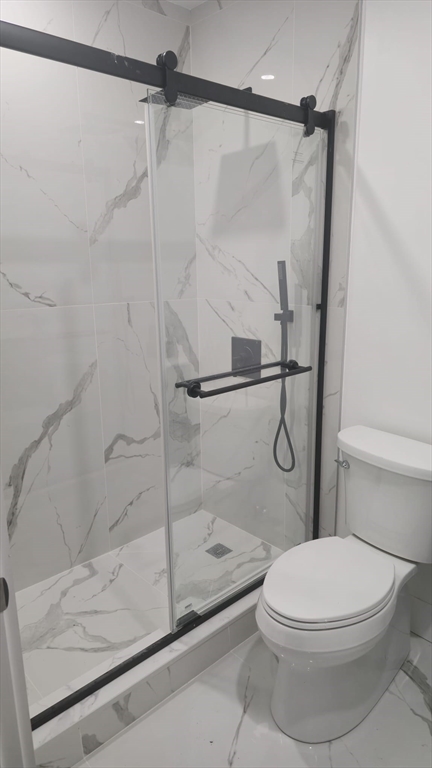 146 Dolphin Avenue, Unit 2 Revere, MA 02151 - Photo 3 of 4 a bathroom with a shower and a toilet